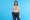 woman holding out the waist band of large pants to indicate weight loss