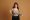 Young ginger woman smiling while posing with measuring tape
