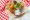 Delicious donuts with icing on plate on wooden background