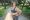 Fat woman and sports. Girl doing exercise for weight loss in the fresh air and laughing in camera after training.