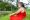 latina-woman-in-a-red-dress-sitting-on-the-lawn