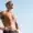 Fit man standing confidently in the sun after hormone replacement therapy.