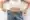 Woman shows off loose jeans after body transformation with skinny shots.