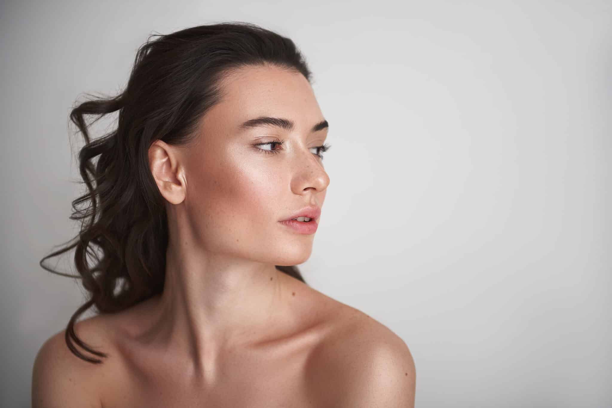 Woman with glowing, youthful skin after BBL treatment.
