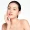 Woman with glowing skin showcasing results of facial balancing.