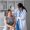 Female doctor and elderly female patient consulting about health problems in clinic.