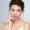 Woman with radiant skin gently touching her face post dermal fillers.