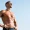 Fit man standing confidently in the sun after hormone replacement therapy.